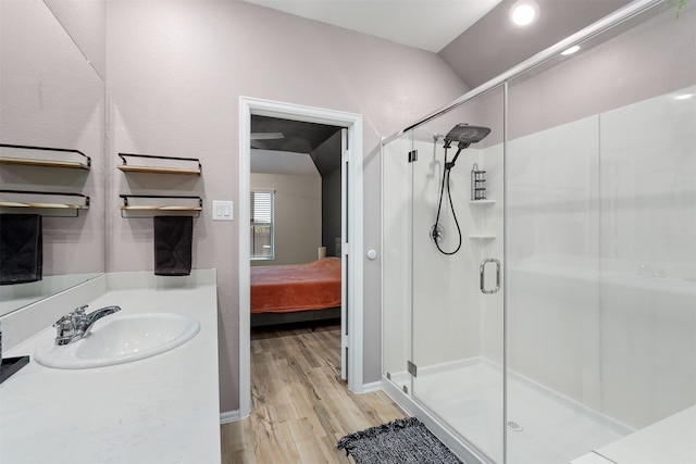 bathroom with vanity, wood-type flooring, lofted ceiling, and an enclosed shower