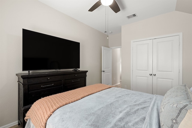 bedroom with vaulted ceiling, a closet, and ceiling fan