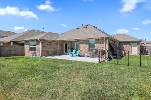 back of property featuring a patio and a yard