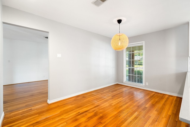 unfurnished room featuring hardwood / wood-style flooring