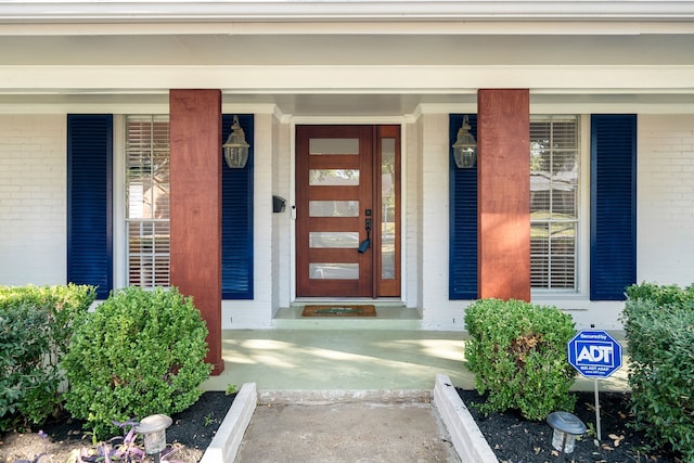 view of exterior entry featuring a porch