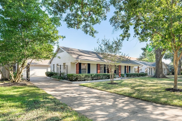 ranch-style house featuring a front lawn, covered porch, and a garage