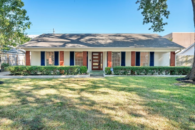 ranch-style home featuring a porch and a front yard