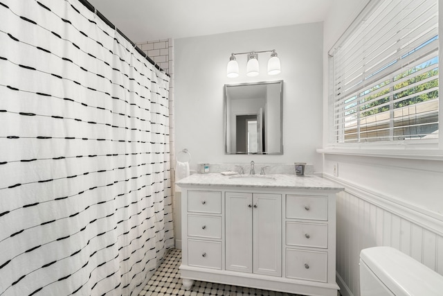 bathroom with tile patterned flooring, a shower with curtain, vanity, and toilet