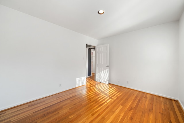 spare room with wood-type flooring