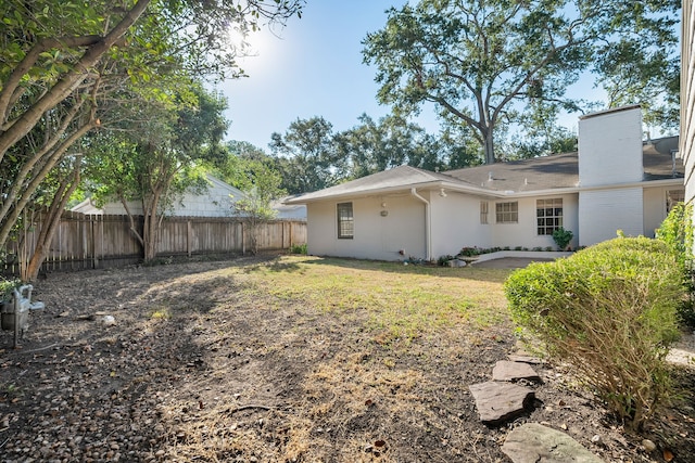 rear view of house featuring a lawn