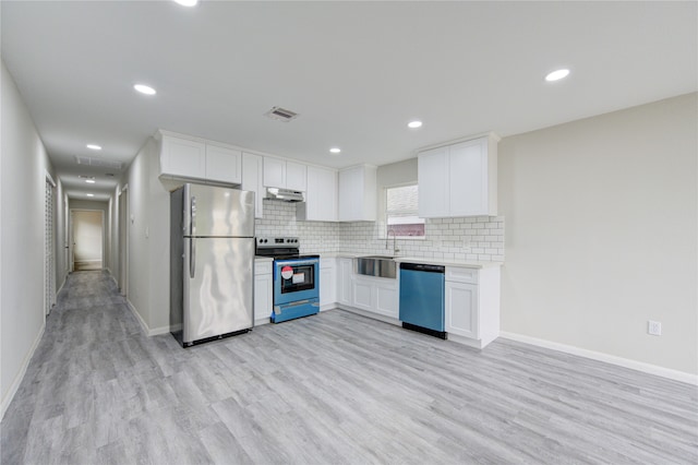 kitchen with white cabinetry, sink, light hardwood / wood-style flooring, and stainless steel appliances