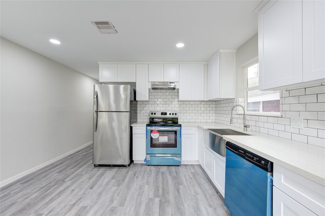 kitchen with light hardwood / wood-style flooring, stainless steel appliances, sink, and white cabinetry