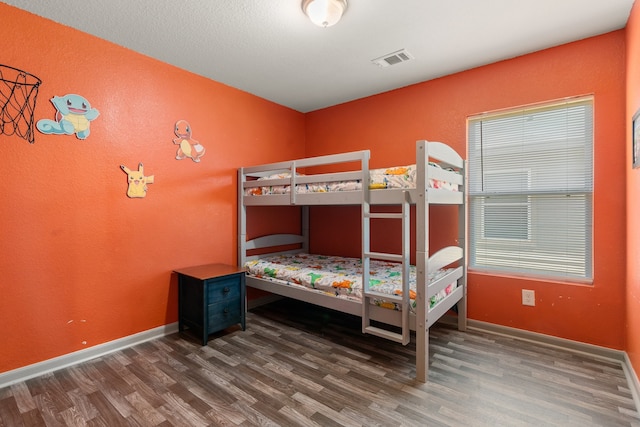 bedroom with dark hardwood / wood-style flooring