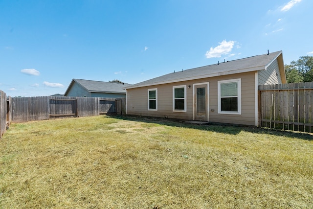 rear view of property with a yard