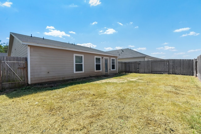 back of property featuring a yard