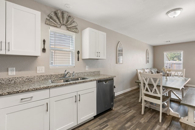 kitchen featuring white cabinetry, sink, light stone counters, dark hardwood / wood-style flooring, and stainless steel dishwasher