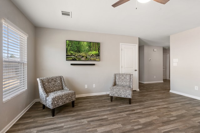 sitting room with dark hardwood / wood-style flooring and ceiling fan