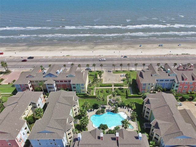 bird's eye view featuring a water view and a beach view