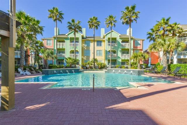 view of swimming pool with pool water feature