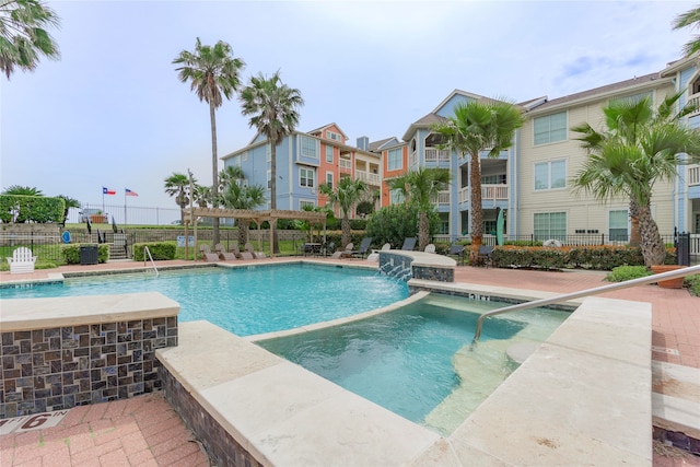 view of pool featuring pool water feature and a pergola