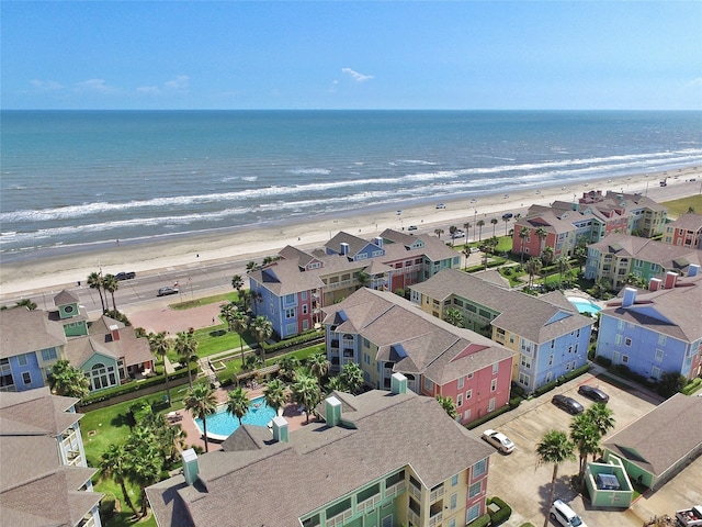 drone / aerial view with a water view and a beach view