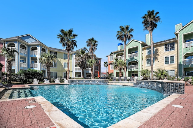 view of swimming pool with pool water feature