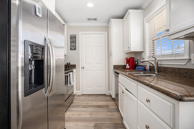 kitchen featuring stainless steel appliances, white cabinetry, crown molding, and sink