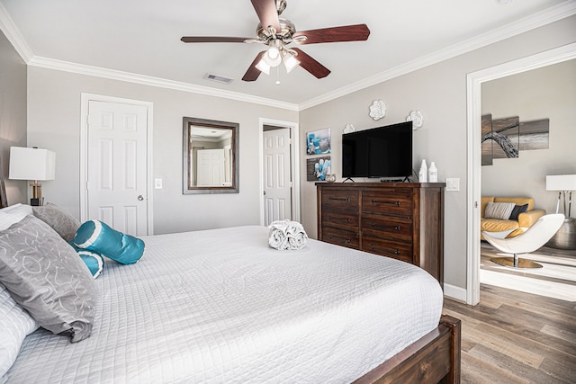 bedroom featuring wood-type flooring, ceiling fan, and crown molding