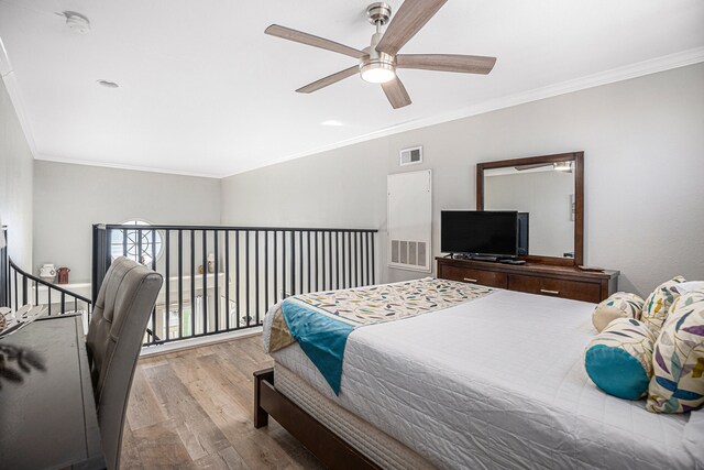 bedroom featuring ceiling fan, ornamental molding, and light wood-type flooring