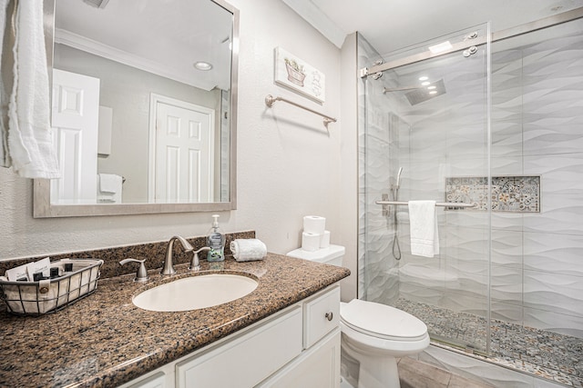 bathroom with vanity, toilet, walk in shower, and crown molding