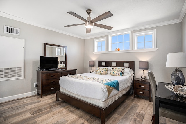 bedroom featuring ceiling fan, wood-type flooring, and ornamental molding