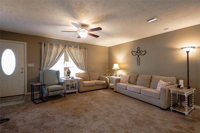 living room with ceiling fan, a textured ceiling, and carpet flooring