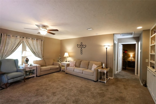 carpeted living room featuring a textured ceiling and ceiling fan