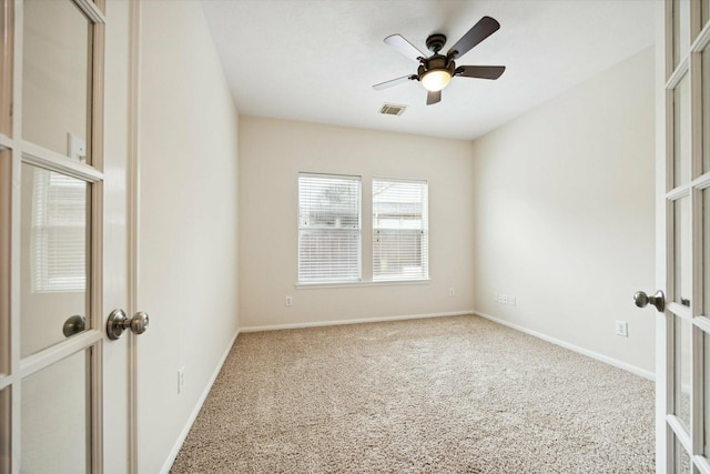 empty room with carpet flooring, ceiling fan, and french doors