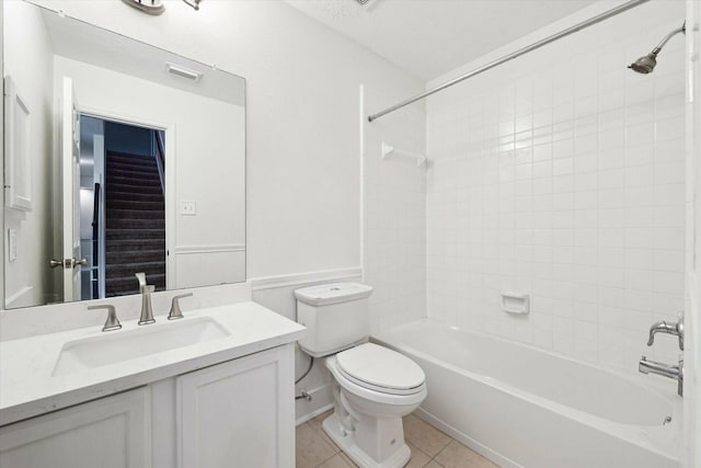 full bathroom with tile patterned flooring, vanity, toilet, and tiled shower / bath combo