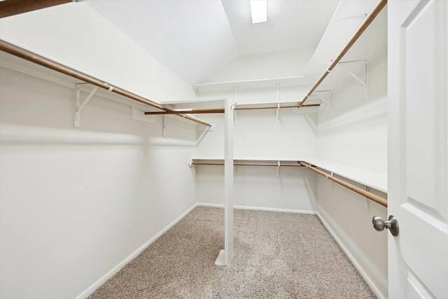 walk in closet featuring carpet flooring and lofted ceiling