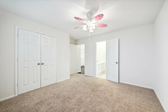 unfurnished bedroom with carpet flooring, ceiling fan, connected bathroom, and a closet