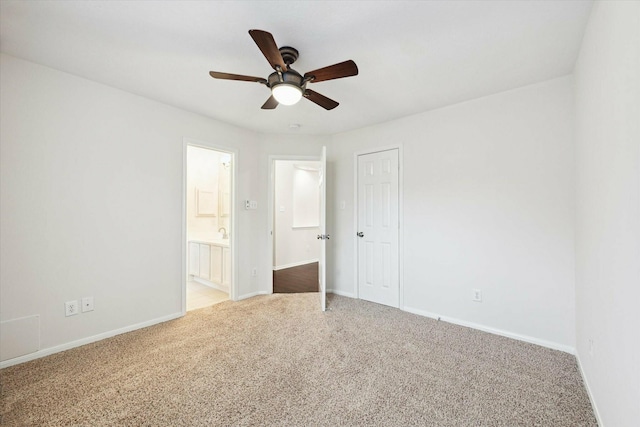 unfurnished bedroom featuring ensuite bath, ceiling fan, a closet, and carpet