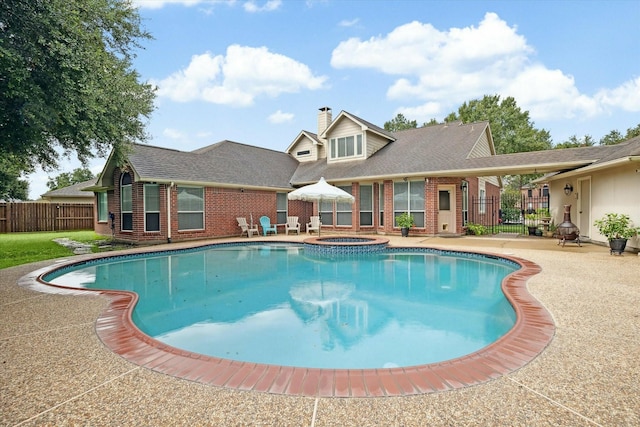 view of pool with an in ground hot tub and a patio