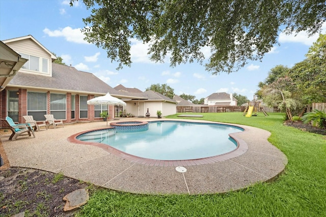 view of pool with a playground, a patio area, a yard, and an in ground hot tub