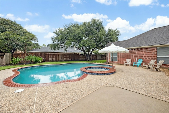 view of swimming pool featuring an in ground hot tub and a patio area