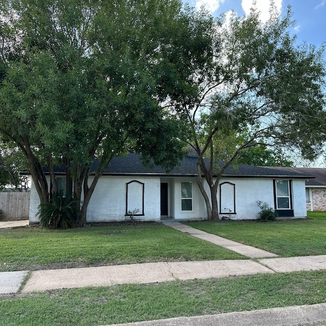 ranch-style house with a front lawn