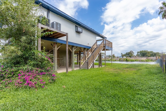 view of yard with a patio, a wooden deck, and central AC