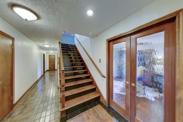 interior space with french doors and a textured ceiling