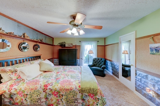 bedroom featuring a textured ceiling, carpet floors, and ceiling fan