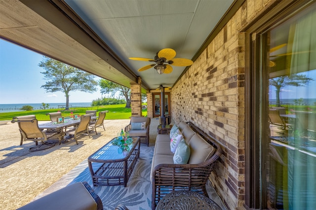 view of patio featuring ceiling fan, a water view, and an outdoor hangout area