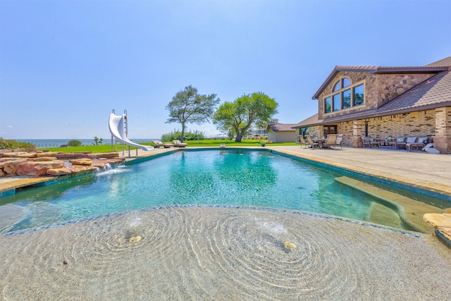 view of pool featuring a patio and a water slide