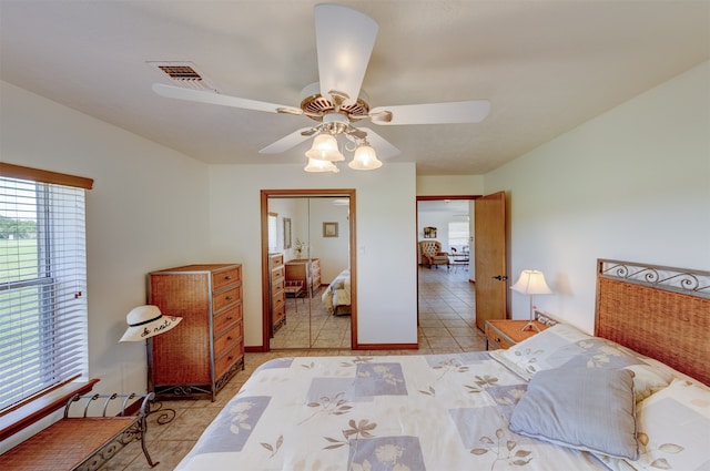 tiled bedroom with a closet and ceiling fan