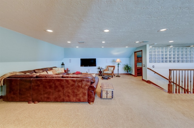 carpeted living room with lofted ceiling and a textured ceiling