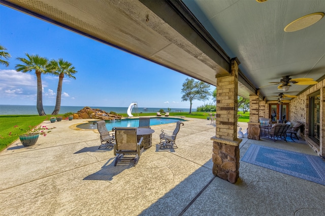 view of patio / terrace with a water view and ceiling fan