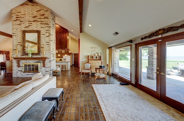 living room featuring beam ceiling, french doors, a fireplace, and dark hardwood / wood-style flooring