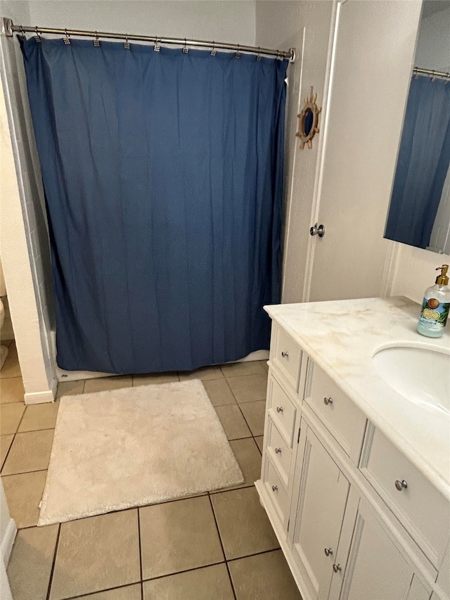 bathroom featuring tile patterned flooring, vanity, toilet, and a shower with curtain