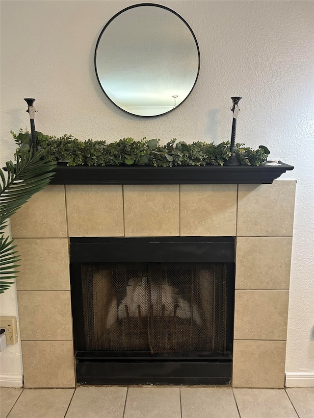 details featuring a tile fireplace and tile patterned floors