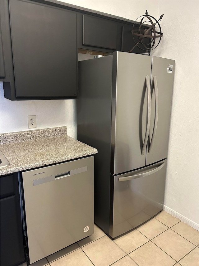 kitchen featuring appliances with stainless steel finishes and light tile patterned flooring